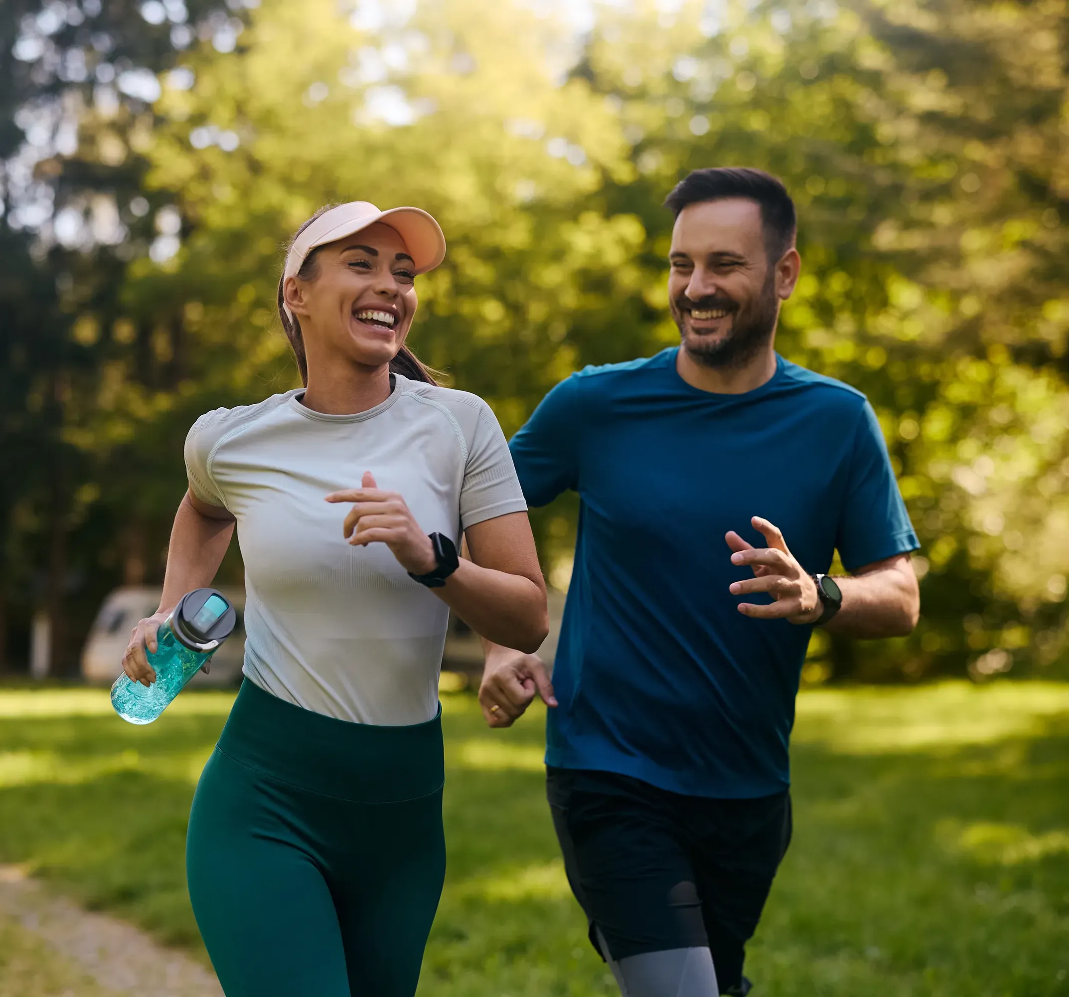 Two people jogging together in a park on a sunny morning